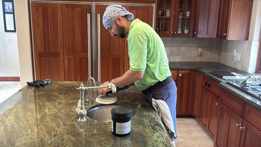 Technician polishing a granite countertop