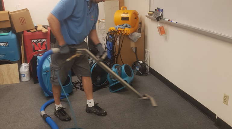 Water damage drying equipment set up on carpet